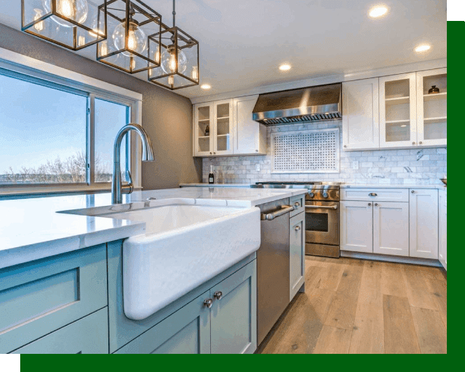 A kitchen with white cabinets and green lights.